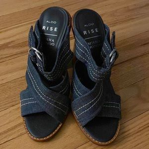 Denim cross over sandal with  chunky wood heel and silver buckle. Gently used